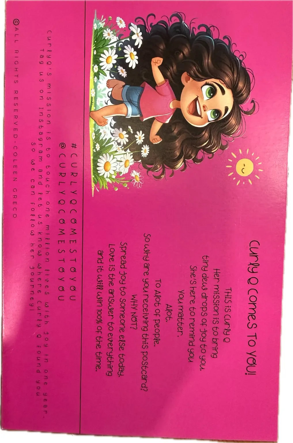 The original bright pink Curly Q postcard, featuring Curly Q among daisies and a smiling sun